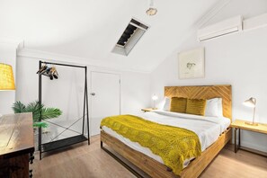 On the top level sits the primary queen-sized bedroom, topped with fresh linens for a good night's sleep. 