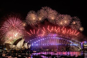 Truly the best seats to enjoy Sydney's NYE fireworks right from the living room or sprawling rooftop.