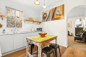 The kitchen is beautifully presented where you'd feel right at home, with a central dining table for four. 