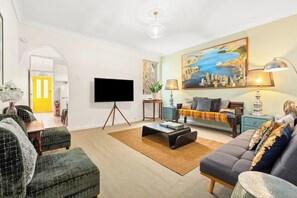 Relax on the sofa with a movie in the main living area, which features ample seating and an eclectic, warm ambience.