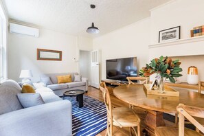 Float effortlessly from the light-soaked living area to a cosy dining space in the downstairs apartment.
