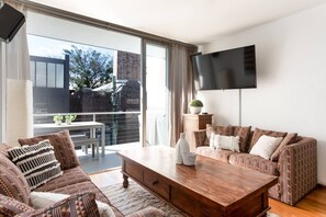 The inviting living area flows to a sunny balcony, where you can sit down together for an alfresco meal. 