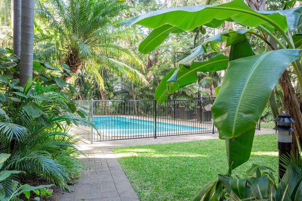 Catch some rays and go for a quick dip in the communal swimming pool surrounded by lush greenery and exotic plants