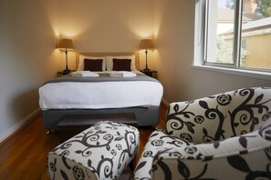 Rest easy in a designer King Koil queen sized bed, topped with luxurious hotel-quality linens. A reading chair is perfect for a cosy afternoon. 