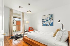The stunning primary bedroom has a designer queen-sized bed by A.H. Beard, topped with luxurious hotel quality linens.
