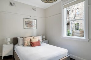 The beautiful bedroom is presented with a queen-sized bed and topped with hotel-quality linens to ensure a good night’s sleep.