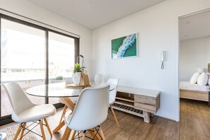 A stylish glass-topped dining table comfortable sits four people. There is also a dining table on the balcony for alfresco evenings.