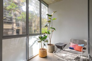 The enclosed balcony is seamlessly connected to the living area and provides a sunny space to relax and unwind.