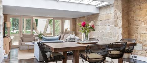 Skylights and large glass doors drench the space in natural light.