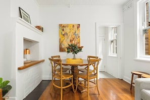 A cosy dining area features a timber dining table that sits 6 nicely and can also function as a workspace