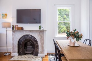 A beautiful ornamental fireplace contributes to the classic heritage charm of this unique Victorian home.