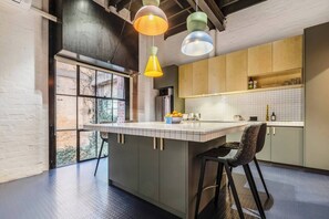 The kitchen centres around a tiled island, offering ample space to dine or chat with the cook while they whip up meals.