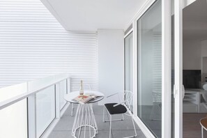 Enjoy a glass of wine before bed or a cup of coffee in the morning on the private balcony off the living room of the apartment