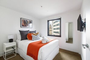  Upstairs, the spacious master bedroom features a queen-size bed and a walk-in robe, with views  of the neighborhood.
