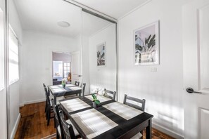 A separate dining room includes a four-seater table to share meals together. 