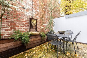 A quaint courtyard creates an idyllic spot to relax with a book or a glass of wine. 