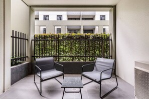 A private balcony with a two-seater setting provides a relaxing spot to enjoy a morning coffee or a glass of wine at sunset. 
