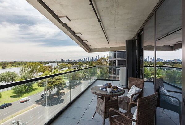 Step out onto the spacious balcony, directly accessible from the living room, and unwind with outdoor seating while soaking in the lush greenery and serene lake views.