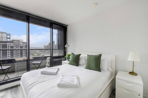 The first queen-sized bedroom opens straight to the balcony, with views directly from the bed.
