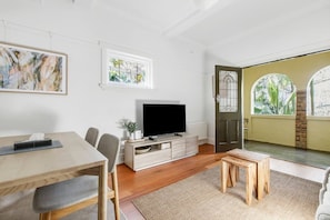 Open plan living flows out to an undercover balcony, providing a seamless transition to the outdoors.