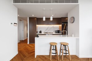 Whip up a meal in the designer centrepiece kitchen, equipped with stainless steel appliances and sleek stone.