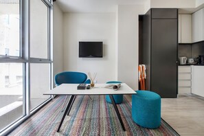  An armchair and stools provide casual seating around the dining table. 