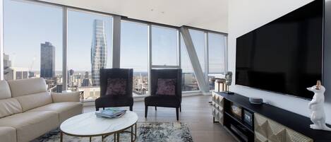 The living room frames uninterrupted panoramic views across Melbourne’s glistening city skyline.
