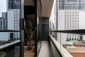 The living room opens directly to the balcony, allowing streams of natural light to flow through.