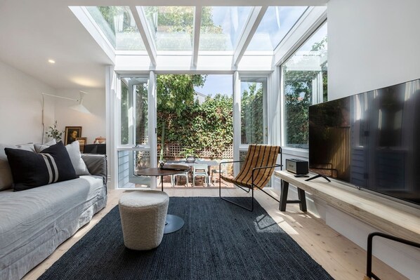 The living and dining area extends to a private courtyard, creating a seamless connection with the outdoors.