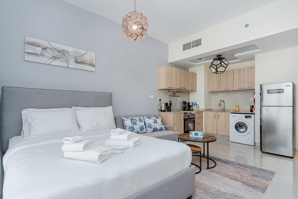 King size bed with linen, towels and blanket.