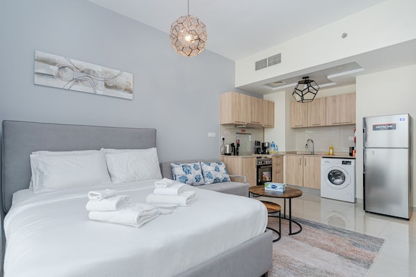 King size bed with linen, towels and blanket.