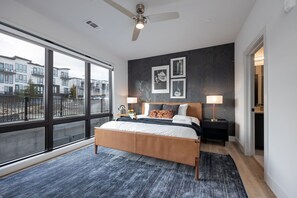 Primary bedroom with King bed, smart TV, large walk-in closet, and ensuite bathroom with walk-in shower.