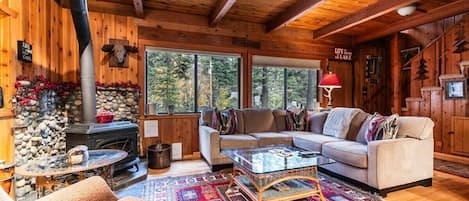 Transport yourself back in time in this cozy and comfortable Tahoe cabin, complete with a woodburning stove and a large L-shaped couch.