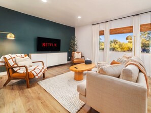 Kick back with shows, games, and puzzles in a cozy, sun-filled living room.