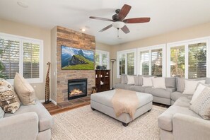 Spacious living room with lots of plush seating on the sectional.