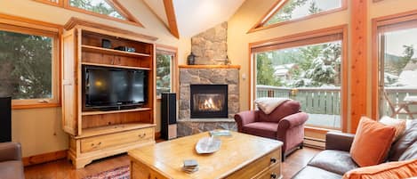 Spacious living area with Smart/Apple TV, gas fireplace, speaker system and vaulted ceilings.