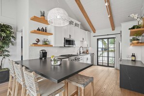 The kitchen is equipped with premium appliances and modern fixtures.