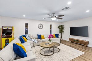 Large living room featuring 75" TV and plenty of seating!