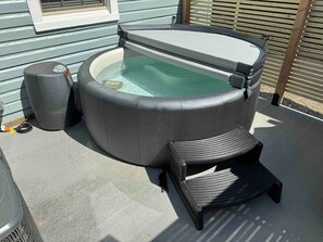Hot tub located on private patio behind the house.