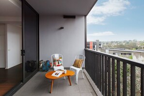 Take it easy on your balcony with alfresco seating and a coffee table.