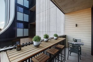 Your private balcony comes complete with a small outdoor table and chairs, as well as a bar-style dining counter