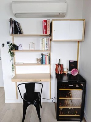 A dedicated workspace with bookshelf.   Wine fridge and AC to enjoy the summer nights.