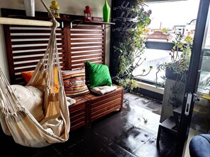 Enjoy some fresh air in the enclosed patio with hammock.