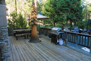 Large deck with dining table. Guests are welcome to use the propane BBQ grill.