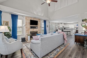 Main living room with smart TV and desk