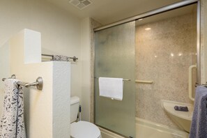 Walk in shower with safety bars.