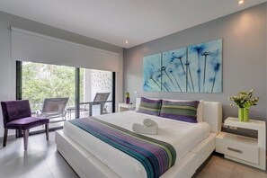 The master bedroom features a king-sized bed & direct access to the balcony