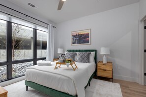Primary Bedroom with a Queen bed, a large walk-in closet, and an ensuite bathroom.