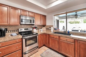 Kitchen with fridge, flattop stove, dishwasher, traditional/ & Keurig coffee maker