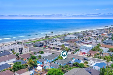 Located one block from the beach, a great surf break, and dining
